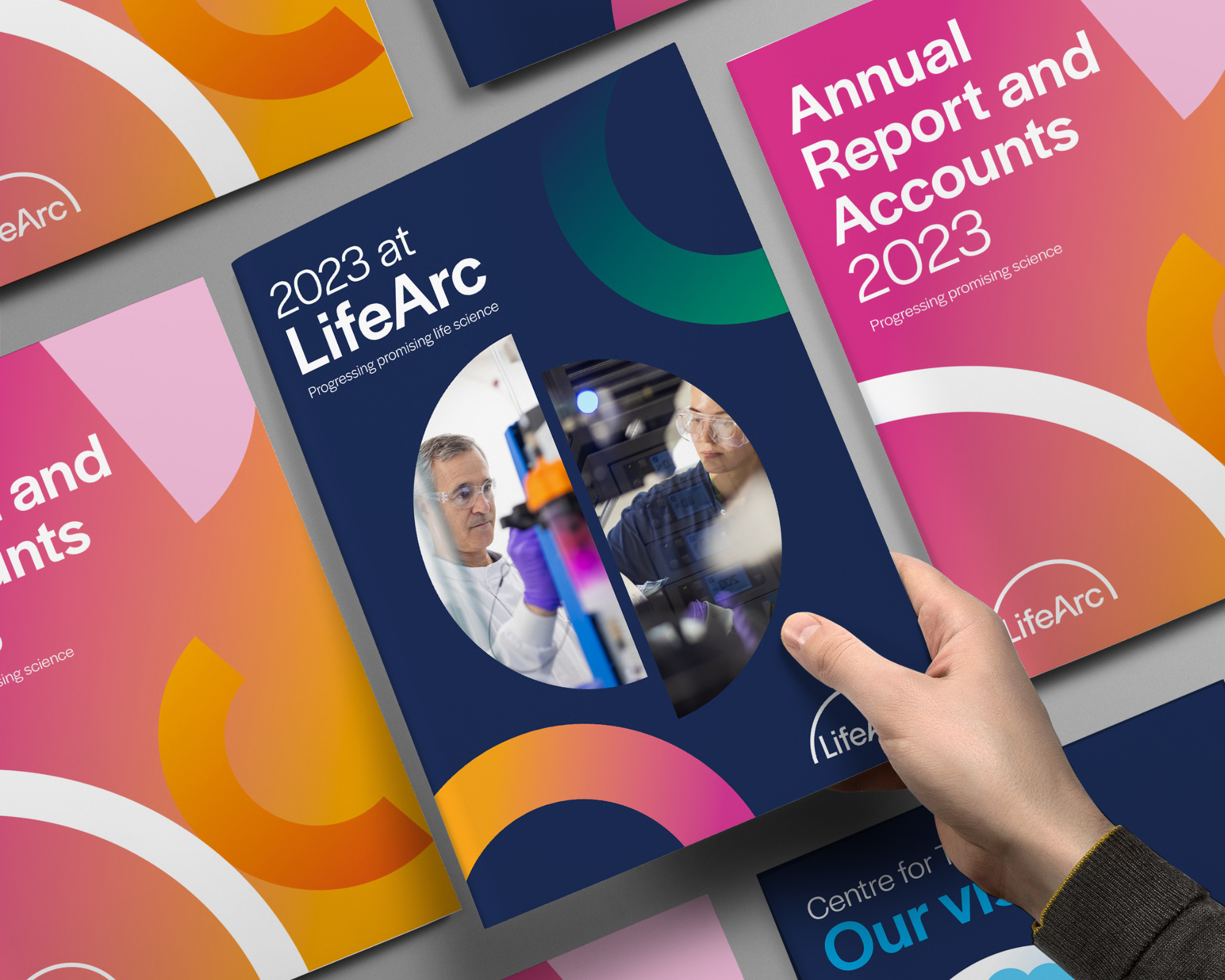 A hand holds a copy of LifeArc's annual report.