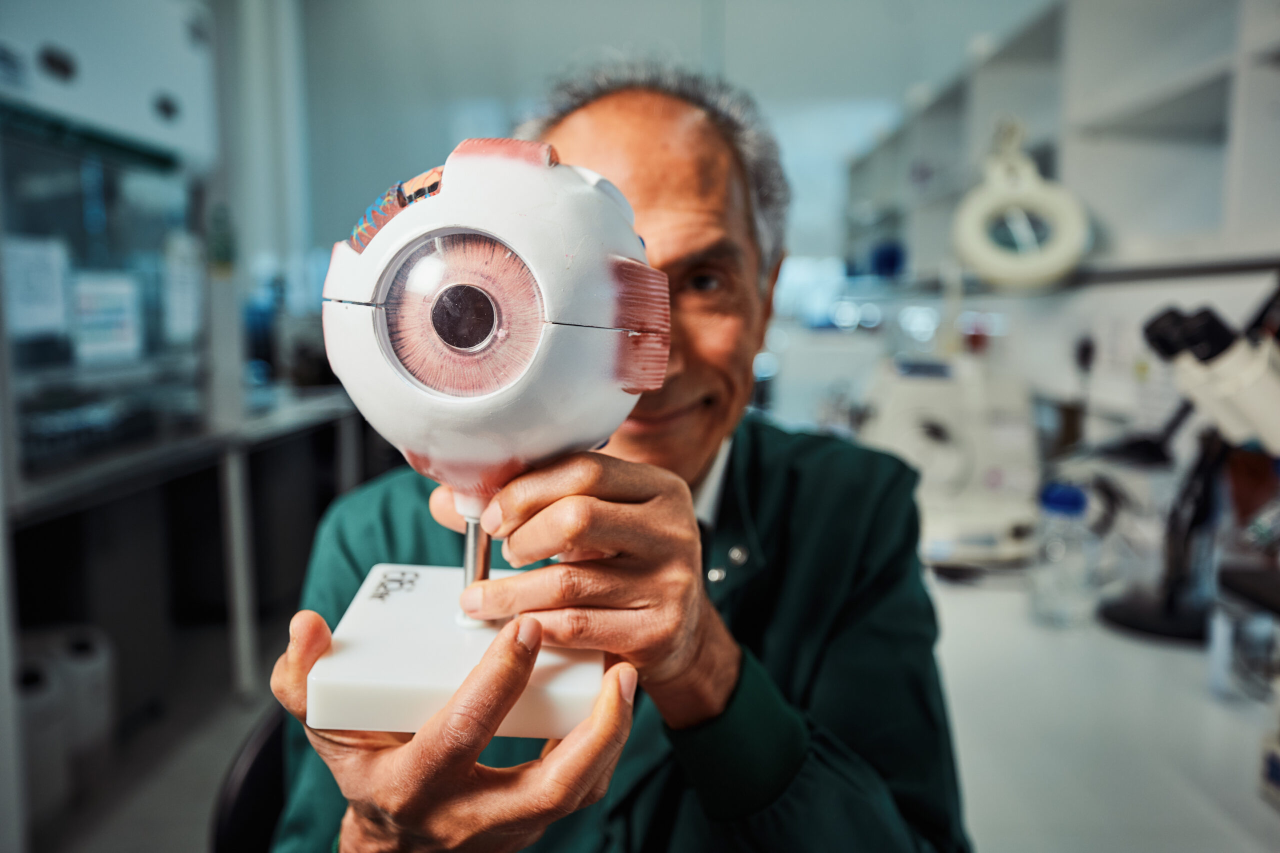 Professor Baljean Dhillon hold model eyeball