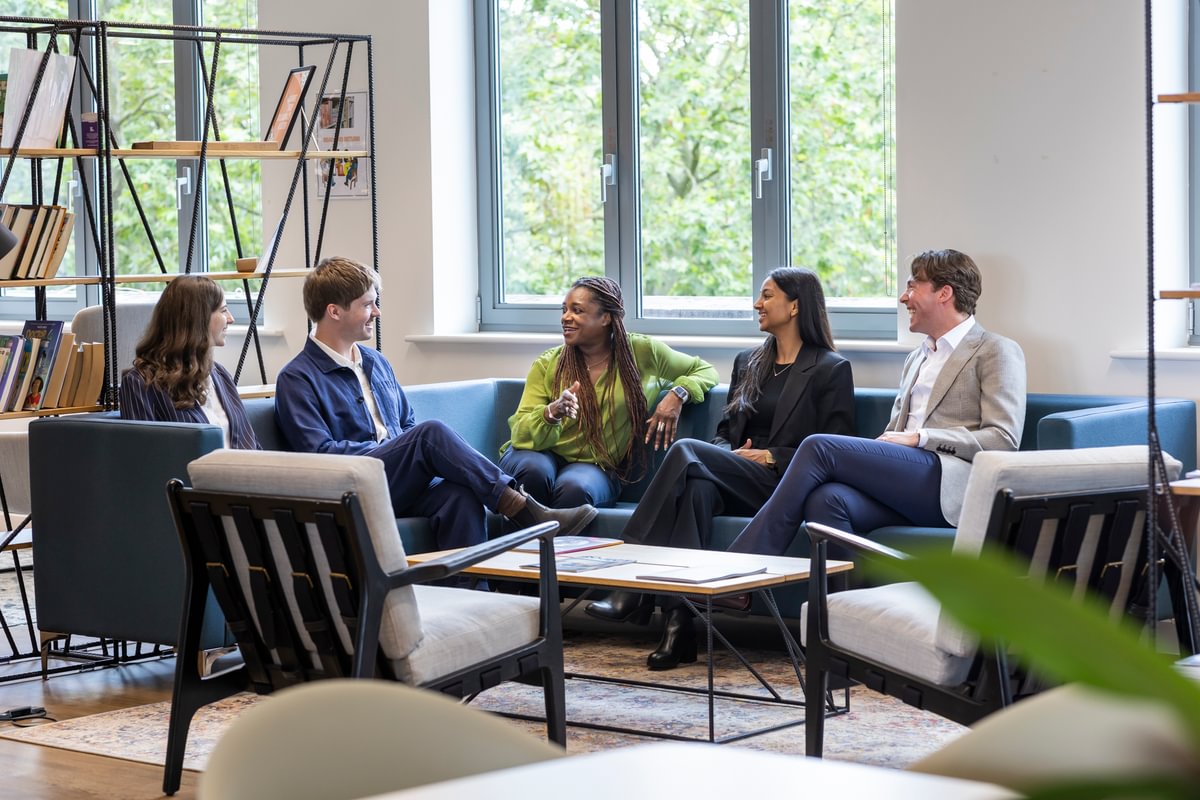 Group of LifeArc fellows sat on the sofa in the office chatting